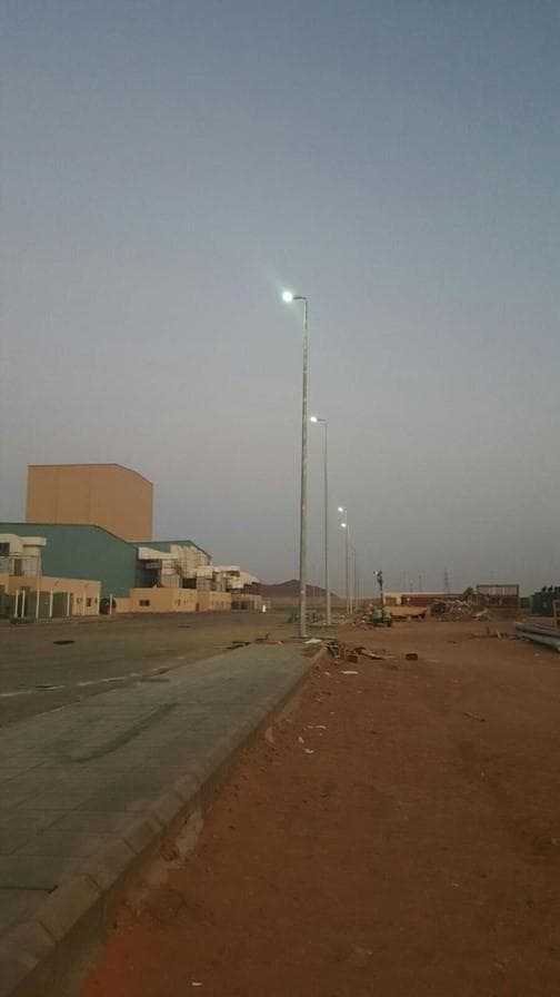Street lighting poles installed along a site road