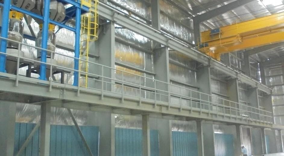 Steel structural elements being installed inside a warehouse