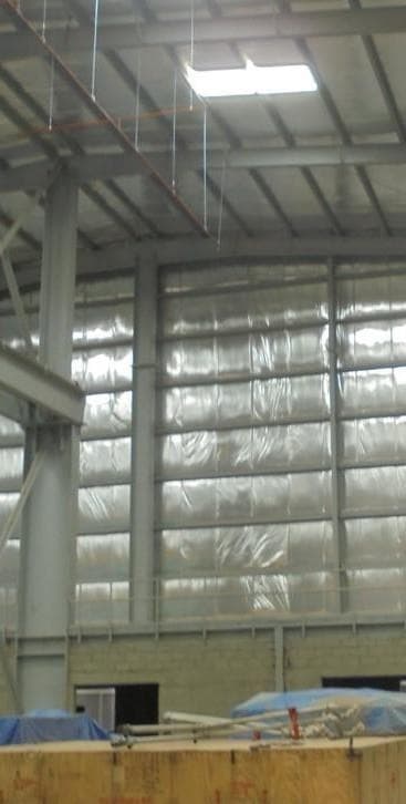 Worker on a lift installing steel structural components
